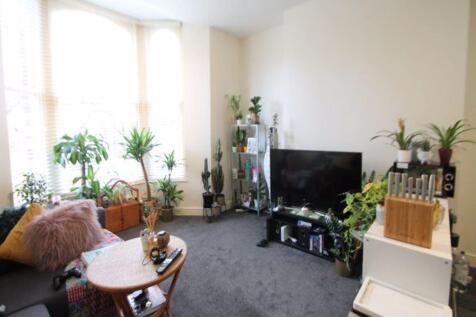 Bright and welcoming living room with ample nat...