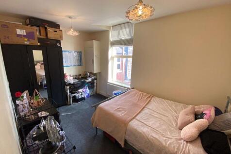 A bright and spacious living room featuring a c...