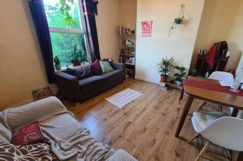 A bright and inviting living room featuring a c...