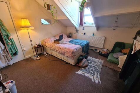 Spacious master bedroom featuring ample space a...