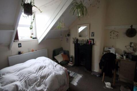 A comfortable master bedroom featuring a large ...