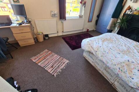 A bright, cozy bedroom featuring a double bed a...