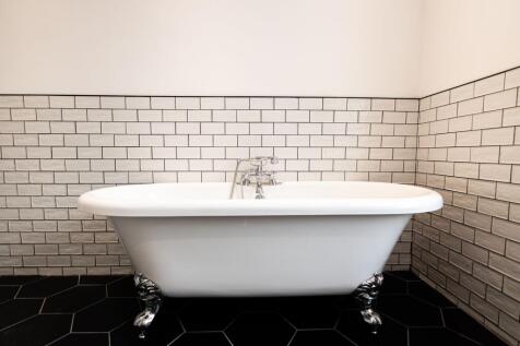 Elegant bathroom featuring a classic clawfoot b...