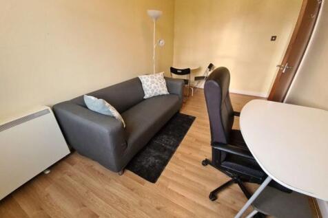 A cozy living area featuring a comfortable dark...