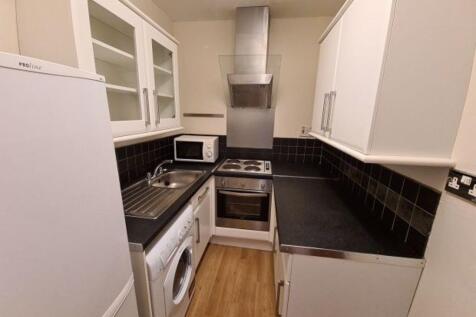 A neat and functional kitchen featuring modern ...