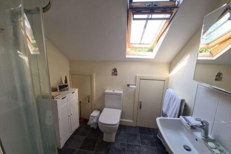 A bright and clean bathroom with a modern toile...