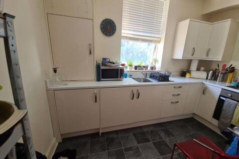 A well-lit kitchen with ample counter space, fe...