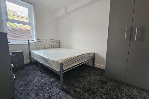 Bright and tidy bedroom featuring a metal-frame...