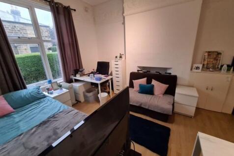 A spacious and well-lit master bedroom featurin...