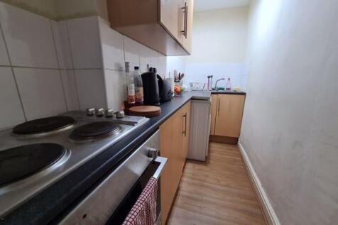 A compact kitchen with basic appliances and goo...