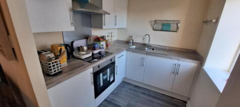 A bright and clean kitchen with ample natural l...