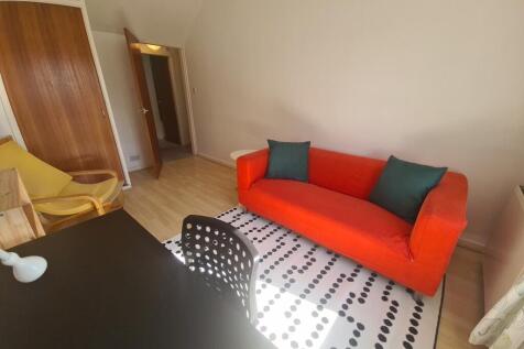 A bright and cozy living room featuring a vibra...