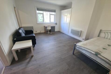 A bright and spacious living room with large wi...