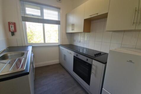 A bright, well-maintained kitchen with ample na...