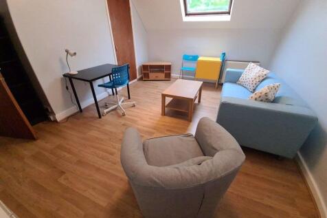 A bright and welcoming living room featuring a ...