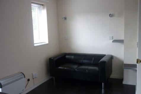 A compact living room featuring a modern black ...