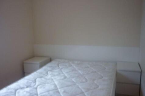 A simple double bedroom featuring a clean mattr...
