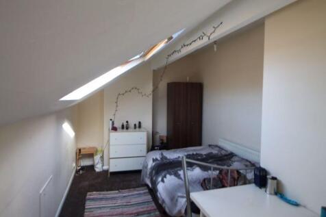 A cozy bedroom with a double bed, a fitted ward...