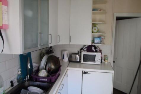 A compact kitchen area with various appliances ...
