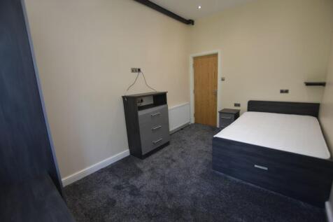 A neat and modern student bedroom featuring a c...