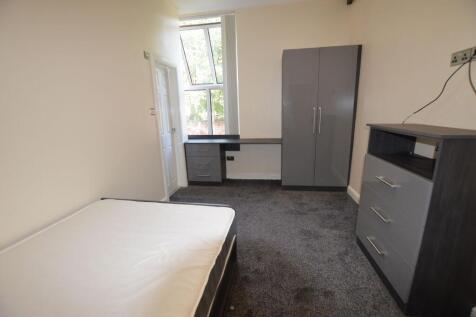 A tidy bedroom featuring modern grey furniture ...