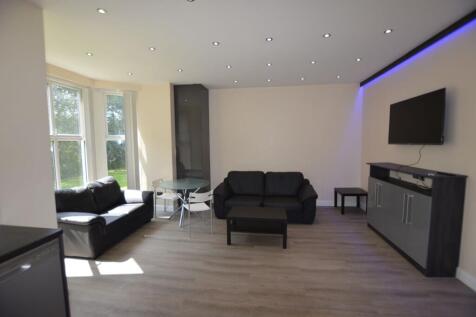 Bright and modern living room featuring two bla...