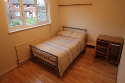 A cozy single bedroom featuring a single bed wi...