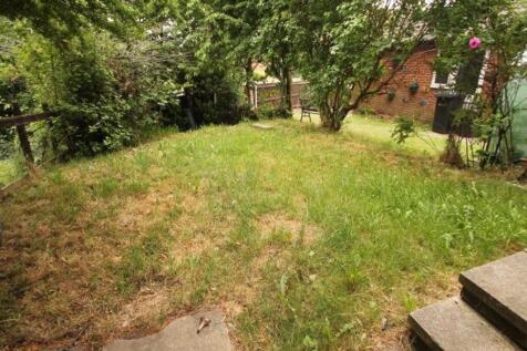 A well-maintained garden area with lush greener...