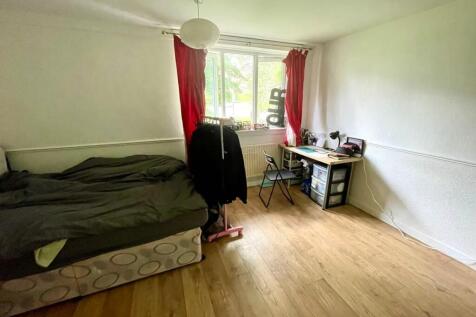 A cozy single bedroom featuring a comfortable b...