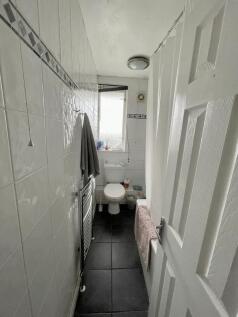 A clean and functional bathroom featuring white...