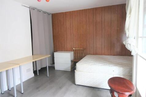 A bright and tidy single bedroom featuring a si...