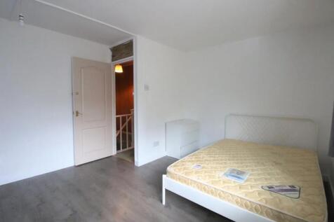 A bright double bedroom featuring a clean, mini...