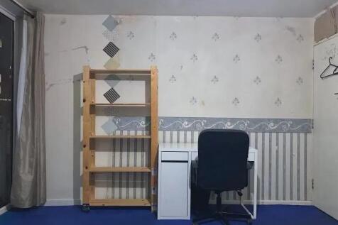 A simple communal workspace featuring a wooden ...