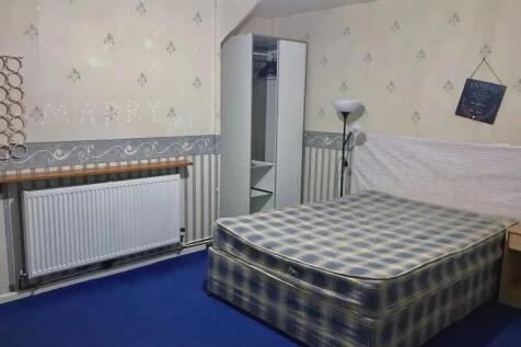 A cozy double bedroom featuring a plaid double ...