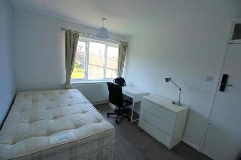 A bright and tidy single bedroom featuring a la...