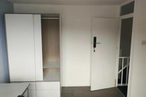 A clean and modern double bedroom featuring a w...