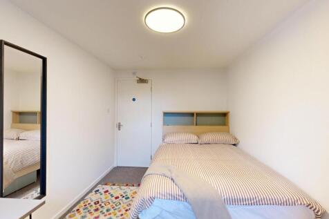 A bright and tidy double bedroom with a comfort...