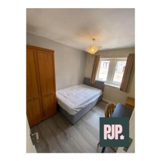 Cozy double bedroom featuring ample natural lig...