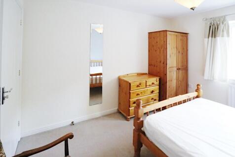 Bright, neutrally decorated bedroom with natura...