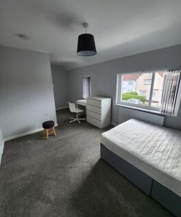 Bright and spacious bedroom with large window a...