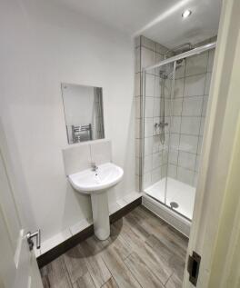 A clean and modern bathroom with a white pedest...
