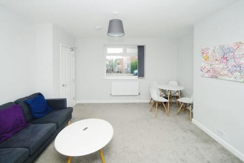 Bright, modern living room with neutral décor, ...