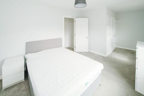 Bright, freshly decorated master bedroom with a...