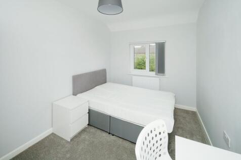 Bright, simply styled bedroom with a double bed...
