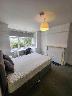 A comfortable double bedroom featuring a large ...