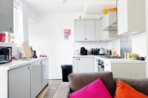 Bright modern kitchen with glossy white cabinet...