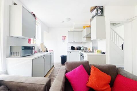 Bright open-plan kitchen and living area with m...