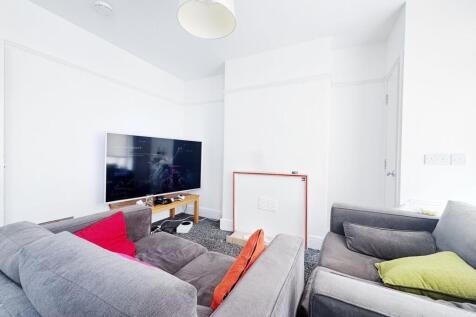 Bright, modern living room with large wall-moun...