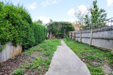 Private rear garden with a paved central path, ...