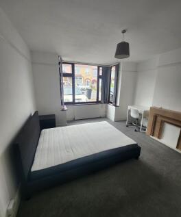 Spacious bedroom featuring a large window that ...